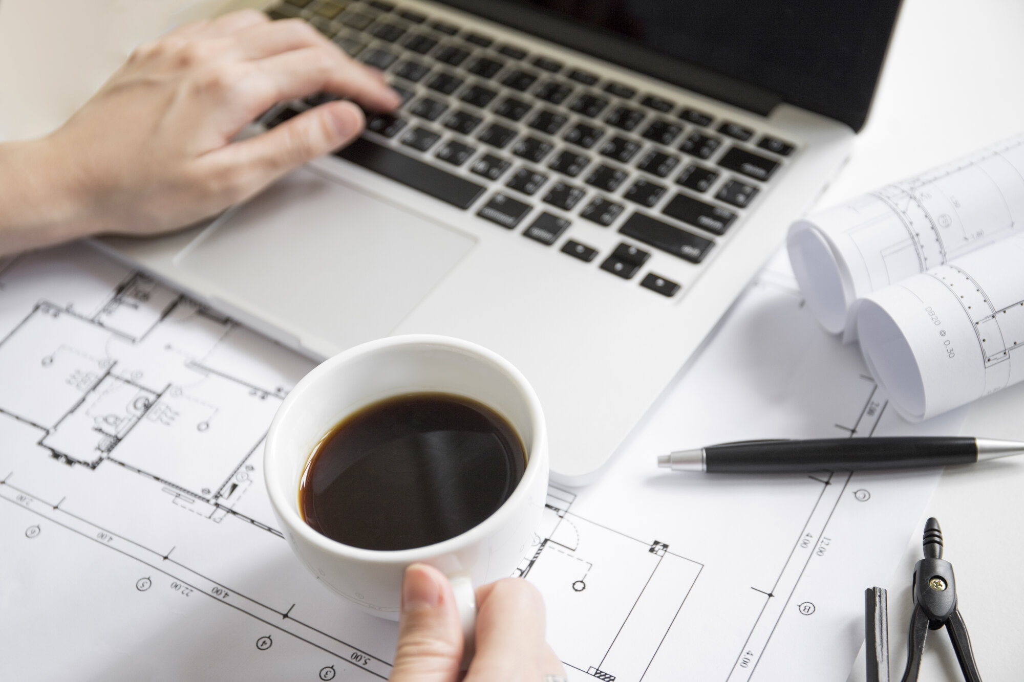 crop hands with coffee using laptop